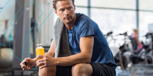 Person at the gym drinking a performance beverage.