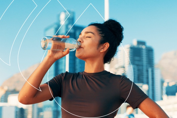 Woman drinking water from a bottle with a city skyline and geometric graphics in the background.